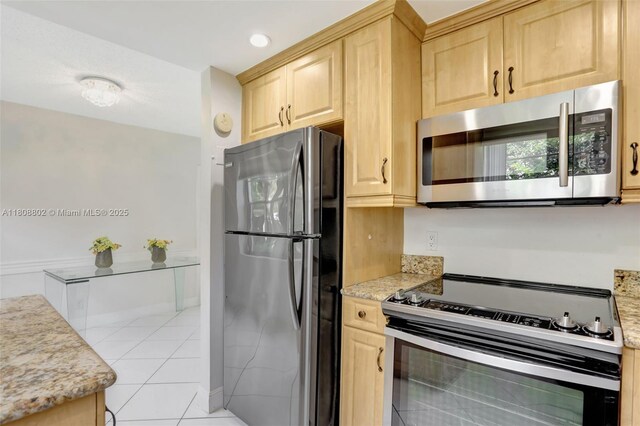 481 Durham Q Unit 481, Deerfield Beach, FL 33442 - kitchen with appliances with stainless steel finishes, light brown cabinetry, light tile patterned floors, and light stone counters