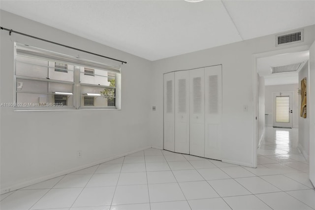 481 Durham Q Unit 481, Deerfield Beach, FL 33442 - unfurnished bedroom featuring baseboards, light tile patterned floors, and a closet