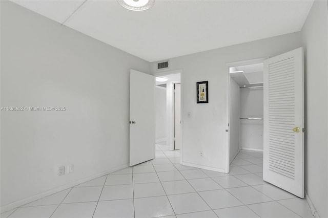 481 Durham Q Unit 481, Deerfield Beach, FL 33442 - unfurnished bedroom with a walk in closet, baseboards, and a closet