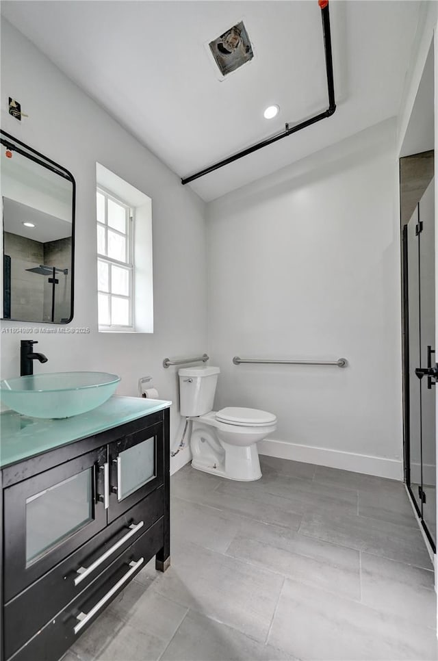 1085 NE 126th St, North Miami Beach, FL 33161 - full bathroom featuring vanity, toilet, a shower stall, baseboards, and recessed lighting
