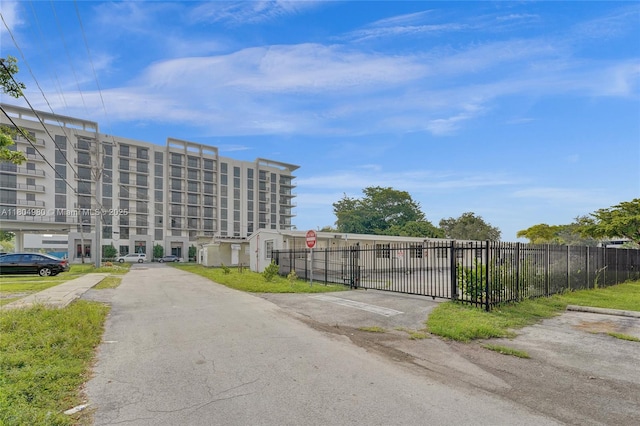 1085 NE 126th St, North Miami Beach, FL 33161 - view of asphalt street with traffic signs and a gate