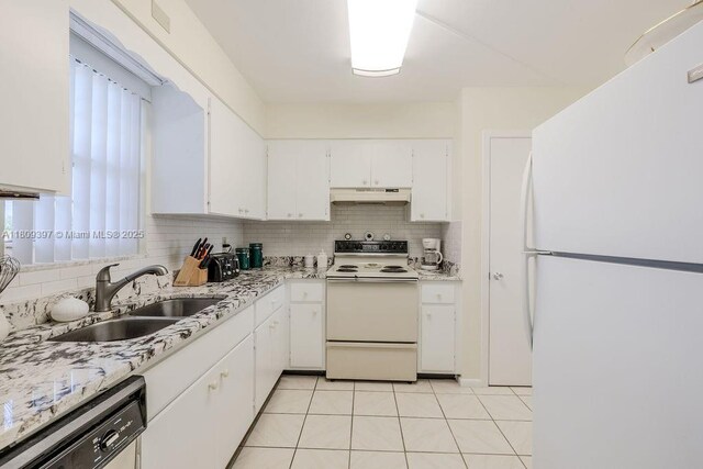 2333 Indian River Blvd Unit 306, Vero Beach, FL 32960 - kitchen with white appliances, a sink, under cabinet range hood, white cabinets, and light countertops