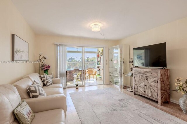 2333 Indian River Blvd Unit 306, Vero Beach, FL 32960 - living room featuring wood finished floors and baseboards
