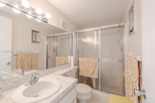2333 Indian River Blvd Unit 306, Vero Beach, FL 32960 - full bath featuring a shower stall, vanity, toilet, and tile patterned flooring