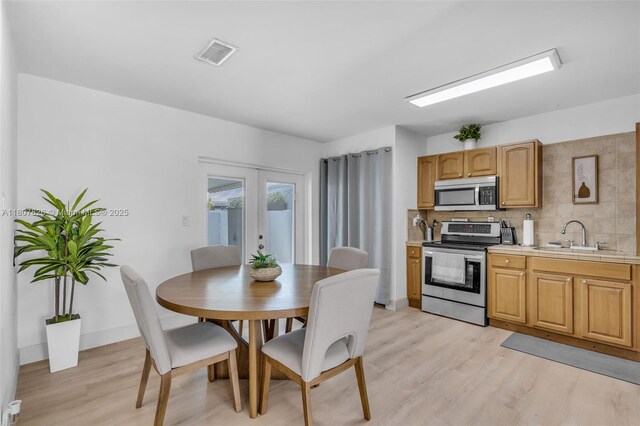 12946 SW 47th Ter, Miami, FL 33175 - dining room featuring light wood-style floors and baseboards