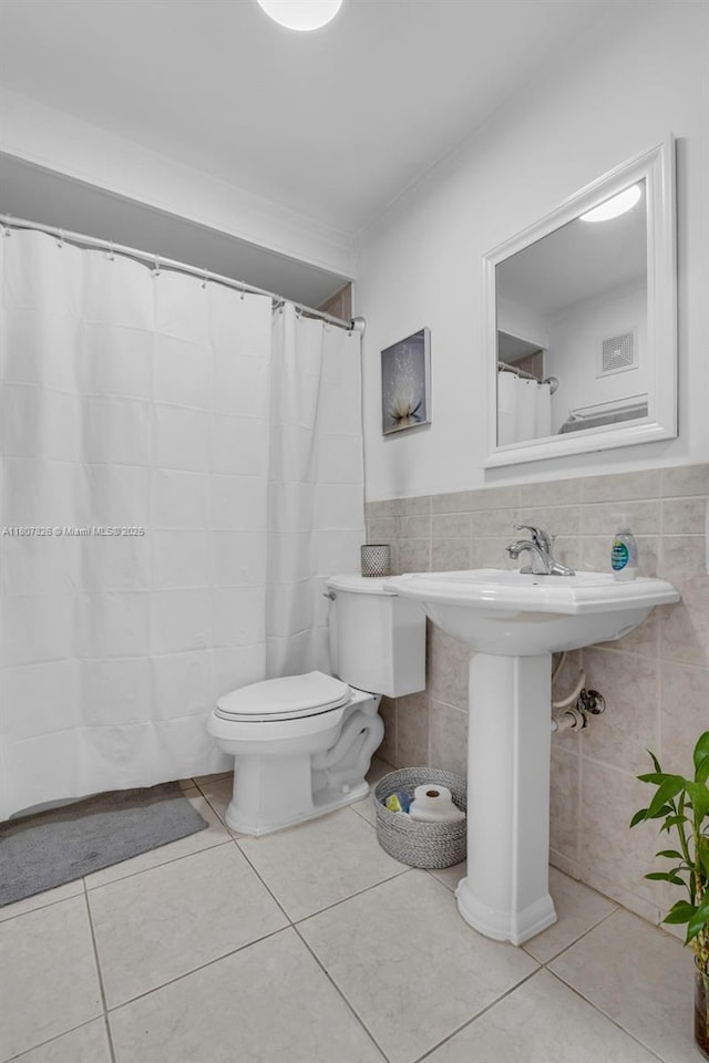 12946 SW 47th Ter, Miami, FL 33175 - bathroom with toilet, tile walls, tile patterned flooring, and a sink