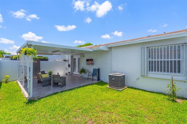 12946 SW 47th Ter, Miami, FL 33175 - back of property featuring cooling unit, stucco siding, a patio area, and french doors
