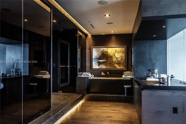 200 Biscayne Boulevard Way Unit 5404, Miami, FL 33131 - full bathroom featuring a garden tub, wood finished floors, a stall shower, and a sink