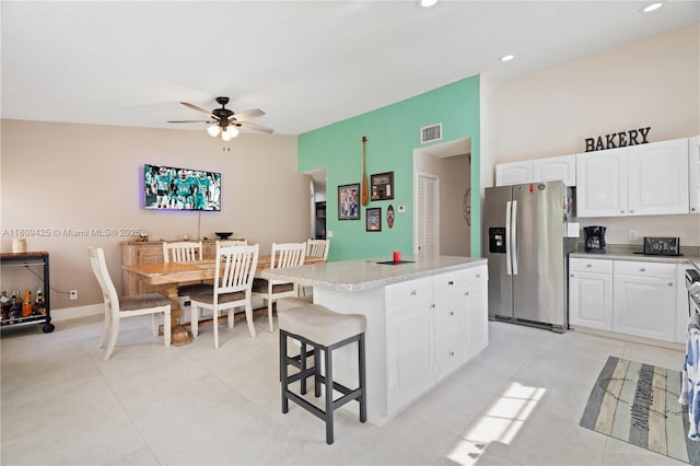 14912 SW 139th Ave, Miami, FL 33186 - kitchen featuring stainless steel fridge with ice dispenser, light countertops, a center island, a ceiling fan, and white cabinetry