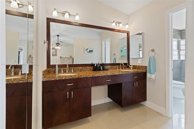 14912 SW 139th Ave, Miami, FL 33186 - full bathroom with double vanity, ceiling fan, toilet, baseboards, and tile patterned floors