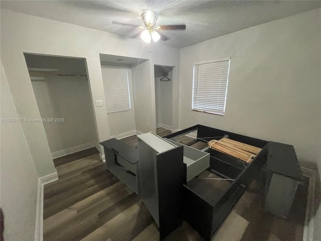 18201 NW 4th Ave, Miami Gardens, FL 33169 - bedroom with dark wood finished floors, a textured ceiling, a ceiling fan, and baseboards