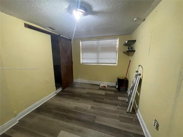 18201 NW 4th Ave, Miami Gardens, FL 33169 - unfurnished room featuring a textured ceiling, wood finished floors, and baseboards