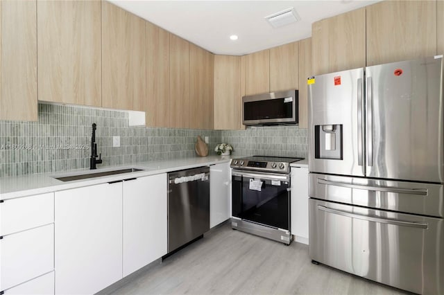 11250 SW 157th Ct, Miami, FL 33196 - kitchen featuring stainless steel appliances, modern cabinets, a sink, and light countertops