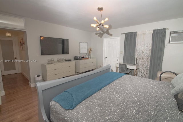 9301 SW 37th St, Miami, FL 33165 - bedroom featuring wood finished floors, a chandelier, baseboards, and an AC wall unit