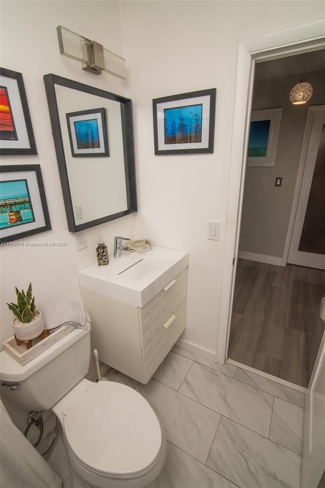 9301 SW 37th St, Miami, FL 33165 - bathroom featuring toilet, vanity, marble look tile flooring, and baseboards