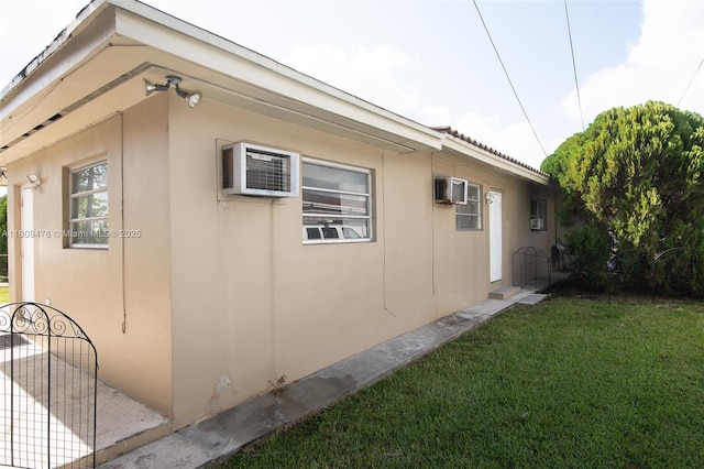 9301 SW 37th St, Miami, FL 33165 - view of home's exterior with a yard, stucco siding, and a wall unit AC