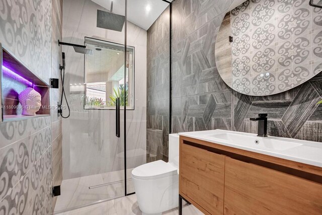 8580 Egret Lakes Ln, West Palm Beach, FL 33412 - bathroom with a shower stall, vanity, and tile walls