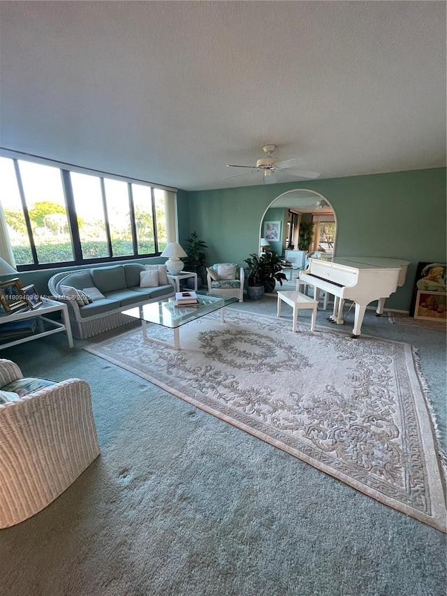1480 Sheridan St Unit 17B, Hollywood, FL 33020 - living room featuring carpet floors, a textured ceiling, a ceiling fan, and arched walkways