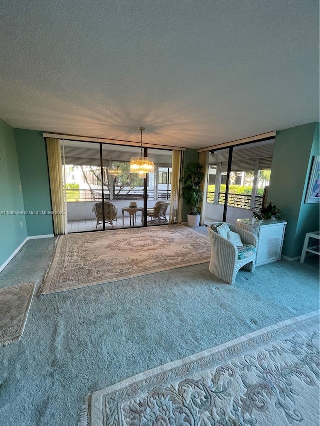 1480 Sheridan St Unit 17B, Hollywood, FL 33020 - living room with a textured ceiling, carpet, a chandelier, and baseboards