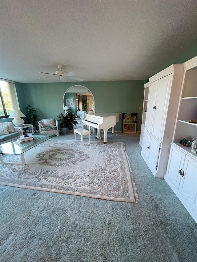1480 Sheridan St Unit 17B, Hollywood, FL 33020 - living area featuring a textured ceiling, carpet, ceiling fan, and arched walkways