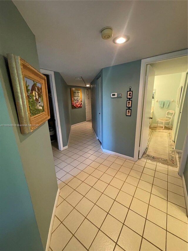 1480 Sheridan St Unit 17B, Hollywood, FL 33020 - corridor with light tile patterned floors and baseboards
