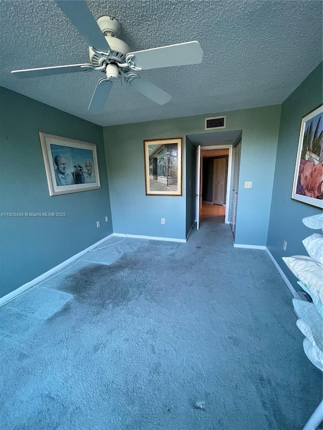 1480 Sheridan St Unit 17B, Hollywood, FL 33020 - empty room with a textured ceiling, carpet flooring, baseboards, and a ceiling fan