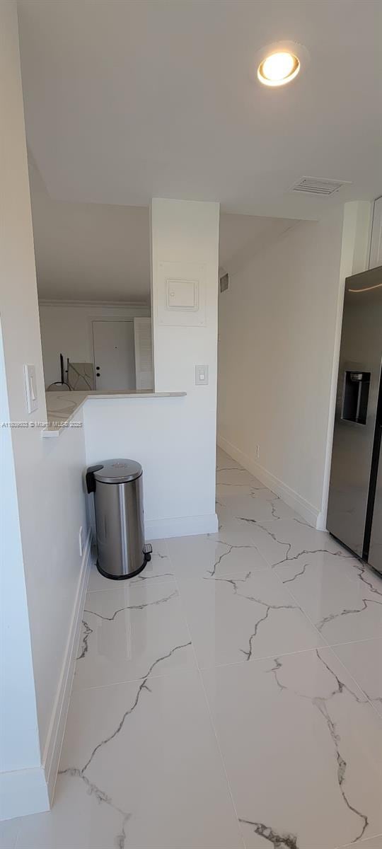2301 NW 41st Ave Unit 209, Lauderhill, FL 33313 - kitchen with baseboards, light stone counters, light marble finish floors, and recessed lighting