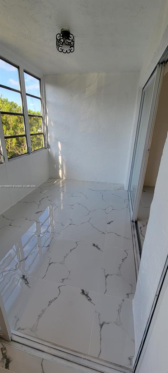 2301 NW 41st Ave Unit 209, Lauderhill, FL 33313 - empty room featuring marble finish floors