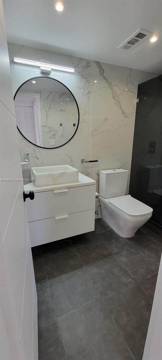 2301 NW 41st Ave Unit 209, Lauderhill, FL 33313 - bathroom with vanity, toilet, and recessed lighting
