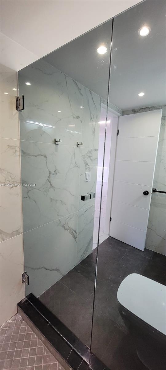 2301 NW 41st Ave Unit 209, Lauderhill, FL 33313 - bathroom with a marble finish shower, toilet, and recessed lighting