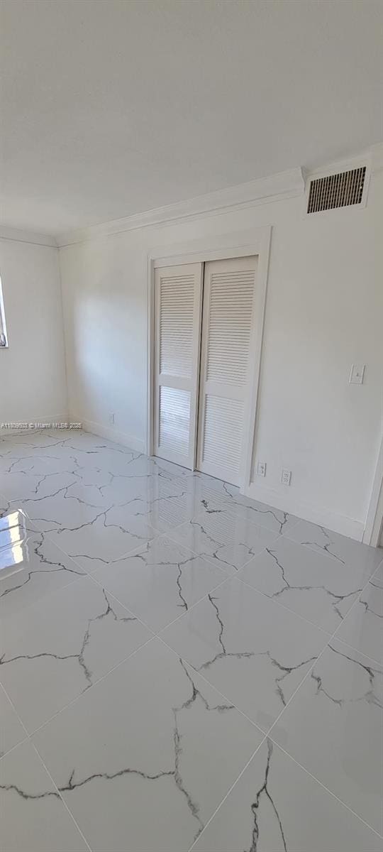2301 NW 41st Ave Unit 209, Lauderhill, FL 33313 - spare room featuring crown molding and marble finish flooring