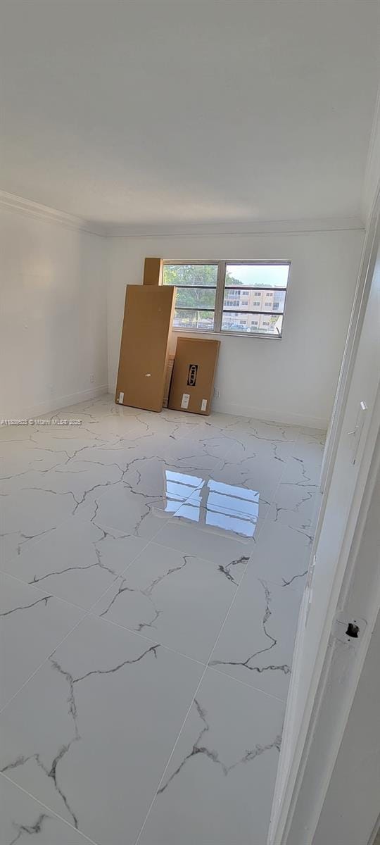 2301 NW 41st Ave Unit 209, Lauderhill, FL 33313 - empty room featuring crown molding and light marble finish floors