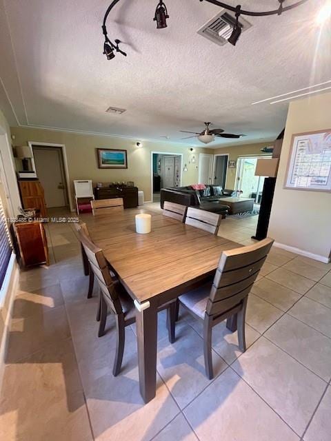 13090 Biscayne Bay Ter, North Miami, FL 33181 - dining space with light tile patterned floors, a textured ceiling, track lighting, and a ceiling fan