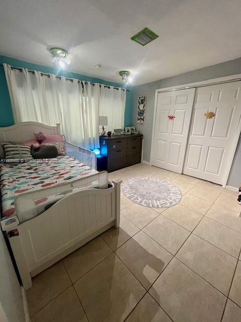 13090 Biscayne Bay Ter, North Miami, FL 33181 - bedroom with light tile patterned floors and a closet