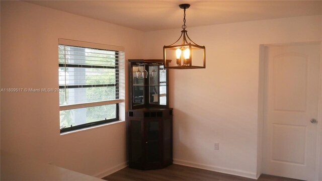 1930 NW 55th St, Miami, FL 33142 - unfurnished dining area with dark wood-style floors and baseboards