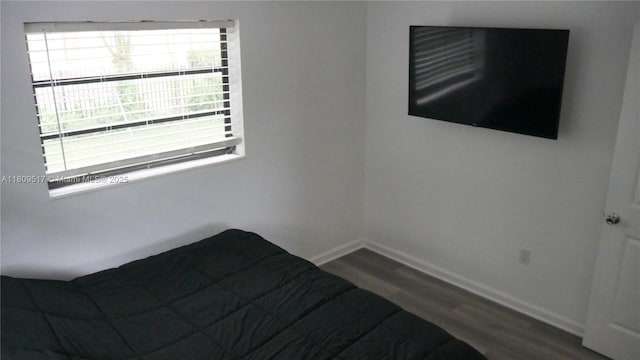 1930 NW 55th St, Miami, FL 33142 - unfurnished bedroom with wood finished floors and baseboards
