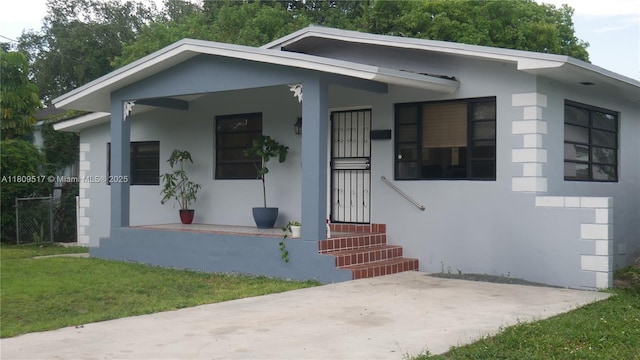 1930 NW 55th St, Miami, FL 33142 - bungalow-style home featuring stucco siding and a front lawn