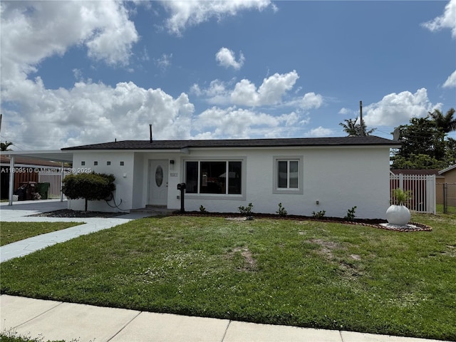 6561 W 13th Ct, Hialeah, FL 33012 - view of front facade featuring stucco siding and a carport