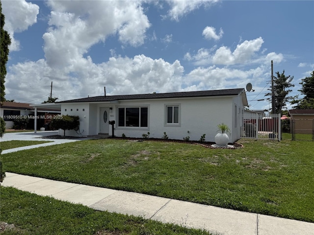 6561 W 13th Ct, Hialeah, FL 33012 - single story home with stucco siding, an attached carport, and concrete driveway