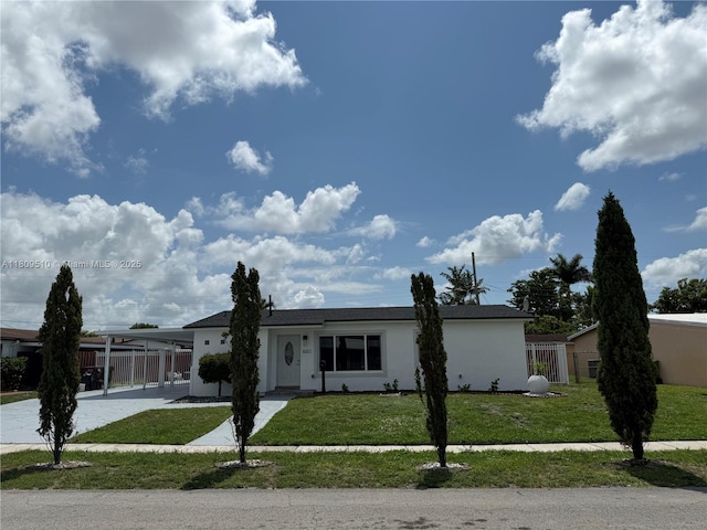 6561 W 13th Ct, Hialeah, FL 33012 - ranch-style home with stucco siding, an attached carport, and driveway