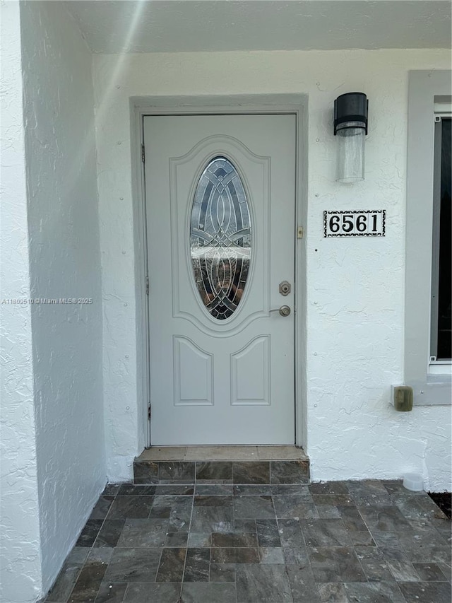 6561 W 13th Ct, Hialeah, FL 33012 - property entrance featuring stucco siding