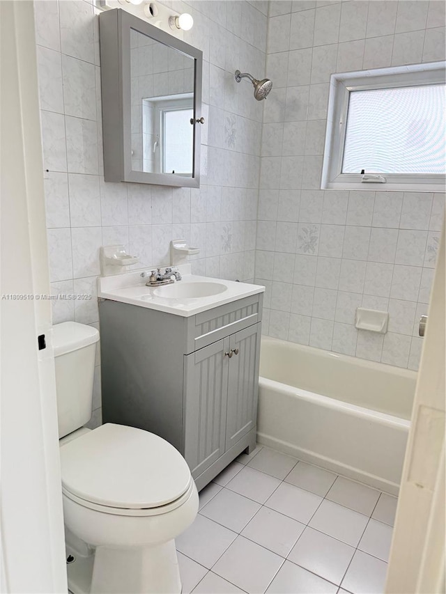 6561 W 13th Ct, Hialeah, FL 33012 - bathroom with tile patterned floors, vanity, tile walls, toilet, and healthy amount of natural light