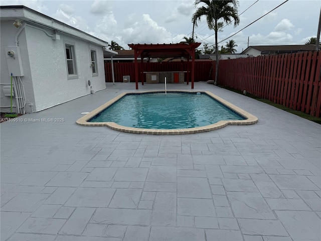 6561 W 13th Ct, Hialeah, FL 33012 - view of swimming pool featuring a pergola, a patio, and a fenced backyard