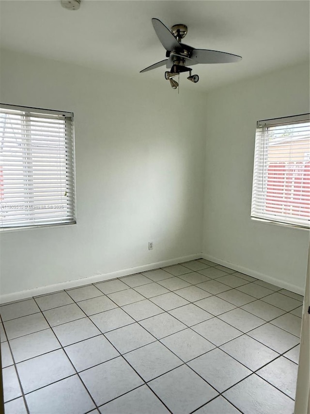 6561 W 13th Ct, Hialeah, FL 33012 - spare room with light tile patterned flooring, ceiling fan, and baseboards