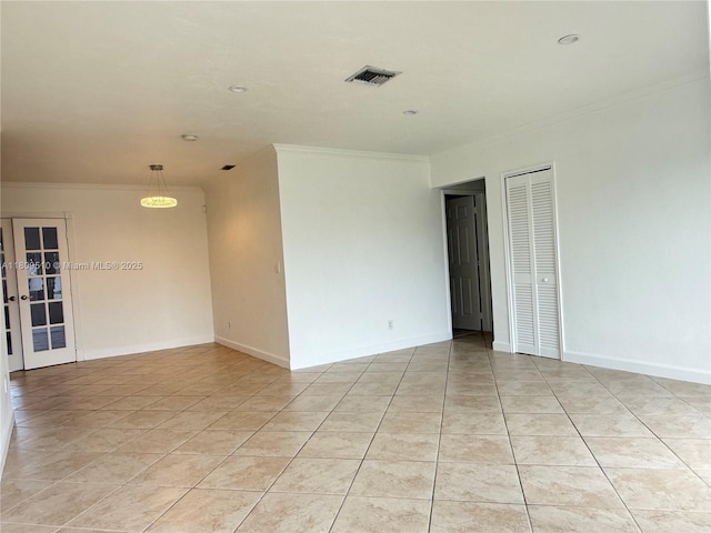 6561 W 13th Ct, Hialeah, FL 33012 - spare room featuring crown molding, light tile patterned floors, and baseboards