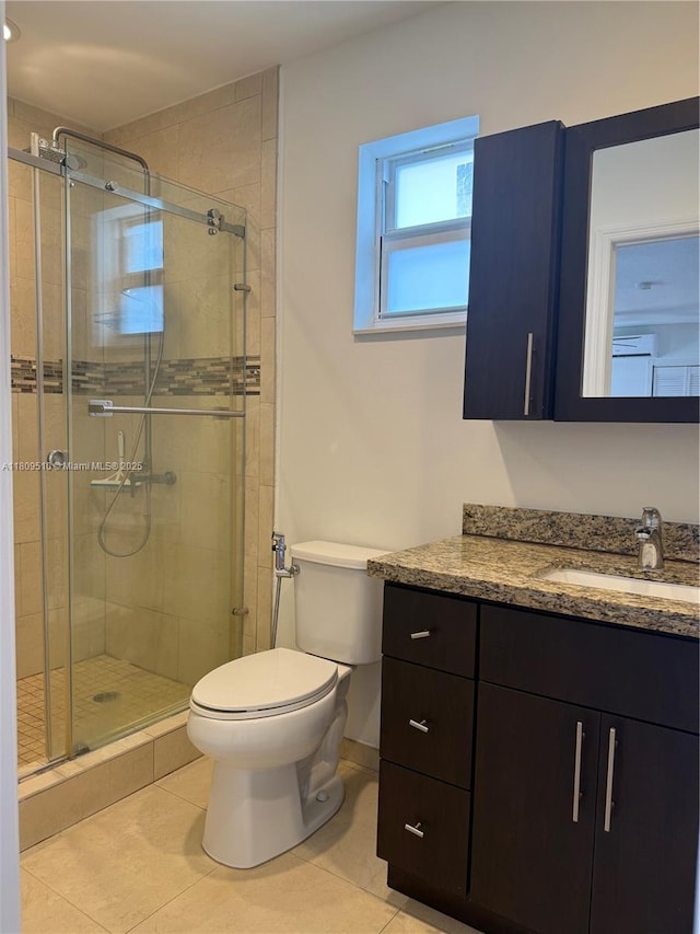 6561 W 13th Ct, Hialeah, FL 33012 - bathroom with toilet, vanity, a stall shower, and tile patterned floors