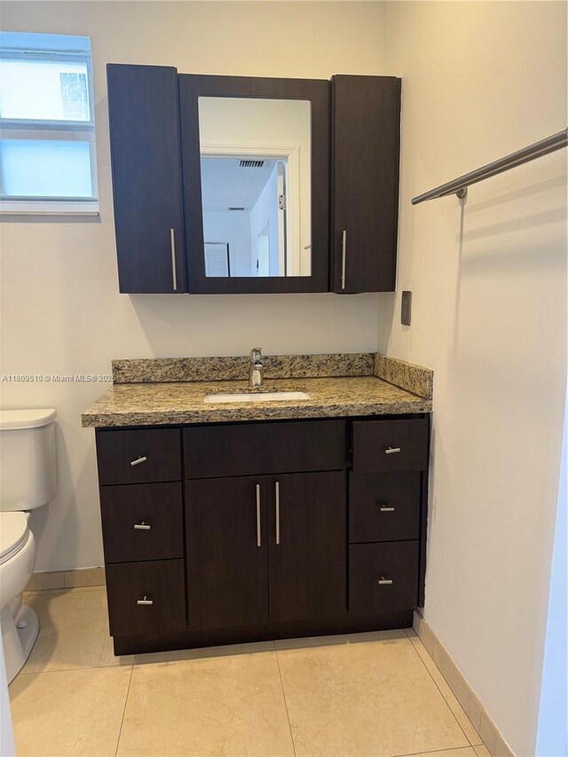 6561 W 13th Ct, Hialeah, FL 33012 - bathroom featuring vanity, baseboards, toilet, and tile patterned flooring