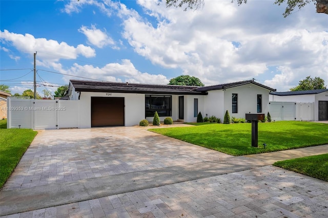 9241 SW 55th St, Cooper City, FL 33328 - view of front of home featuring a gate, decorative driveway, a garage, and stucco siding
