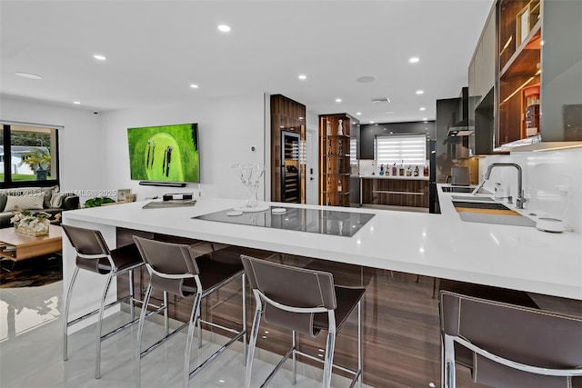 9241 SW 55th St, Cooper City, FL 33328 - kitchen with modern cabinets, a peninsula, light countertops, black electric stovetop, and recessed lighting