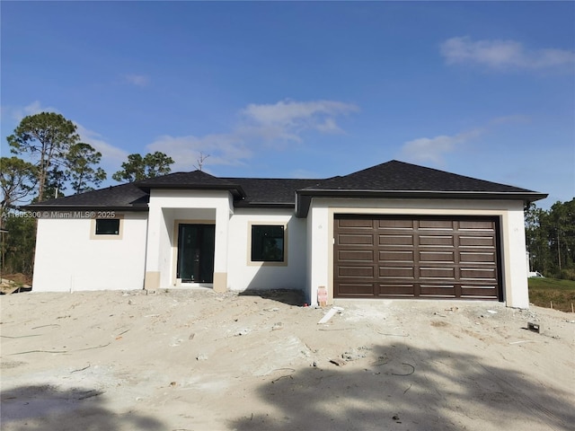 326 Nathan Ave, Lehigh Acres, FL 33974 - view of front of property featuring stucco siding, a garage, and roof with shingles